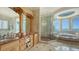 Luxurious bathroom with ocean views, double vanity, and a large glass shower at 3625 Casey Key Rd, Nokomis, FL 34275