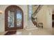 Stunning entryway with marble floors, ornate double doors, and a grand staircase at 3625 Casey Key Rd, Nokomis, FL 34275