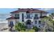 Beachfront home with red tile roof, balcony, and ornate entryway at 3625 Casey Key Rd, Nokomis, FL 34275