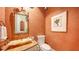 Elegant powder room with a unique vessel sink and artistic wall decor at 3625 Casey Key Rd, Nokomis, FL 34275