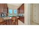 Wet bar with granite countertop and wooden cabinetry at 3625 Casey Key Rd, Nokomis, FL 34275