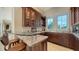 Stylish wet bar features granite countertops and glass shelving at 3625 Casey Key Rd, Nokomis, FL 34275