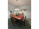 Bright dining room features a large wood table and chandelier at 3682 Lake Bayshore Dr # K402, Bradenton, FL 34205