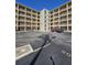 Low angle shot showing parking lot and condo exterior with multiple balconies and unit entrances in the center at 3682 Lake Bayshore Dr # K402, Bradenton, FL 34205