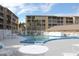 Outdoor community pool with lots of tables and chairs and a building exterior visible in background at 3682 Lake Bayshore Dr # K402, Bradenton, FL 34205