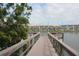 Picturesque water view showcasing a dock with seating, palm trees, and well-maintained buildings at 3682 Lake Bayshore Dr # K402, Bradenton, FL 34205