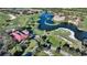 Aerial view of community near golf course and clubhouse at 4201 Palacio Dr, Sarasota, FL 34238