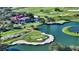 Aerial view of community by golf course and lake at 4201 Palacio Dr, Sarasota, FL 34238