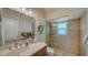 Simple bathroom with single sink, shower, and neutral decor at 4201 Palacio Dr, Sarasota, FL 34238