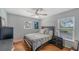 Bright bedroom with a queen-sized bed, hardwood floors, and a ceiling fan at 4201 Palacio Dr, Sarasota, FL 34238