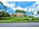 Community clubhouse with landscaping and flag at 4201 Palacio Dr, Sarasota, FL 34238