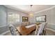 Elegant dining room featuring a wood table and chic chairs at 4201 Palacio Dr, Sarasota, FL 34238