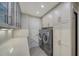 Laundry room with quartz countertop, glass-front cabinets, and washer/dryer at 4201 Palacio Dr, Sarasota, FL 34238