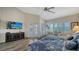 Main bedroom with large TV, hardwood floors and patio access at 4201 Palacio Dr, Sarasota, FL 34238