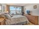 Bedroom with water views and wood dresser at 4310 Falmouth Dr # A104, Longboat Key, FL 34228