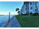 Modern condo building with waterfront access and tropical landscaping at 4310 Falmouth Dr # A104, Longboat Key, FL 34228