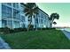 Modern building exterior with waterfront access and lush landscaping at 4310 Falmouth Dr # A104, Longboat Key, FL 34228