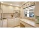 Kitchen boasts white cabinets and modern appliances at 4310 Falmouth Dr # A104, Longboat Key, FL 34228