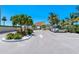 Parking area with a covered pavilion and tropical landscaping at 4310 Falmouth Dr # A104, Longboat Key, FL 34228