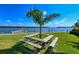 Relaxing waterfront picnic area with wooden tables and benches at 4310 Falmouth Dr # A104, Longboat Key, FL 34228