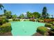 Well-maintained community putting green surrounded by landscaping at 4310 Falmouth Dr # A104, Longboat Key, FL 34228