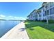 Brick paved walkway beside a waterfront building and lush grass at 4310 Falmouth Dr # A104, Longboat Key, FL 34228