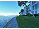 Stunning waterfront view with a paved walkway and tropical landscaping at 4310 Falmouth Dr # A104, Longboat Key, FL 34228