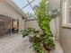 Peaceful courtyard with lush tropical plants and a stone patio at 4539 Longspur Ln, Sarasota, FL 34238