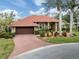 Attractive single-story home with a red tile roof, landscaped yard, and brick driveway at 4539 Longspur Ln, Sarasota, FL 34238