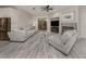 Living room with a fireplace, large TV, and light gray sofas at 4539 Longspur Ln, Sarasota, FL 34238