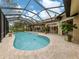 Inviting pool area with covered patio and lush landscaping at 4539 Longspur Ln, Sarasota, FL 34238