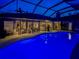 Luminous pool at night with view of living area at 4539 Longspur Ln, Sarasota, FL 34238