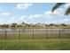 Waterfront backyard with a view of houses across the lake at 4629 Garden Arbor Way, Bradenton, FL 34203