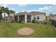 Landscaped backyard with a screened patio and circular fire pit at 4629 Garden Arbor Way, Bradenton, FL 34203