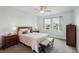 Bright bedroom with a queen-size bed, two windows, and a dresser at 4629 Garden Arbor Way, Bradenton, FL 34203