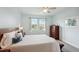 Spacious Primary bedroom with a king-size bed and large windows offering a water view at 4629 Garden Arbor Way, Bradenton, FL 34203