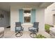 Relaxing front porch with comfortable seating and blue shutters at 4629 Garden Arbor Way, Bradenton, FL 34203