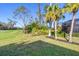 Landscaped backyard with palm trees and view of golf course at 4838 88Th E St, Bradenton, FL 34211