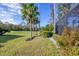 Landscaped backyard with palm trees and view of golf course at 4838 88Th E St, Bradenton, FL 34211