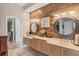 Double vanity bathroom with wood-look tile and large mirrors at 4838 88Th E St, Bradenton, FL 34211