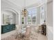 Elegant dining room with a glass table, chandelier, and bay window at 4838 88Th E St, Bradenton, FL 34211