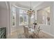 Bright dining room featuring a glass table, chandelier, and window seating at 4838 88Th E St, Bradenton, FL 34211