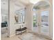 Bright and airy foyer with white shutters and a built-in bench at 4838 88Th E St, Bradenton, FL 34211