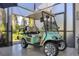 Enclosed patio with a teal and white golf cart at 4838 88Th E St, Bradenton, FL 34211