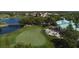 Aerial view of a putting green, clubhouse, and surrounding landscape at 4838 88Th E St, Bradenton, FL 34211