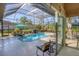 Enclosed pool and patio area with lounge chairs and a view of the garden at 4838 88Th E St, Bradenton, FL 34211