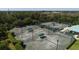 Aerial view of community tennis courts with players and surrounding landscape at 4838 88Th E St, Bradenton, FL 34211