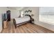 Bright bedroom with wood floors, a double bed, and an ensuite bathroom at 5 Pinehurst Ct, Rotonda West, FL 33947