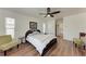 Bedroom with wood floors, double bed, and access to a bathroom at 5 Pinehurst Ct, Rotonda West, FL 33947