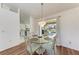 Dining room with glass table and chandelier, view of pool at 5 Pinehurst Ct, Rotonda West, FL 33947